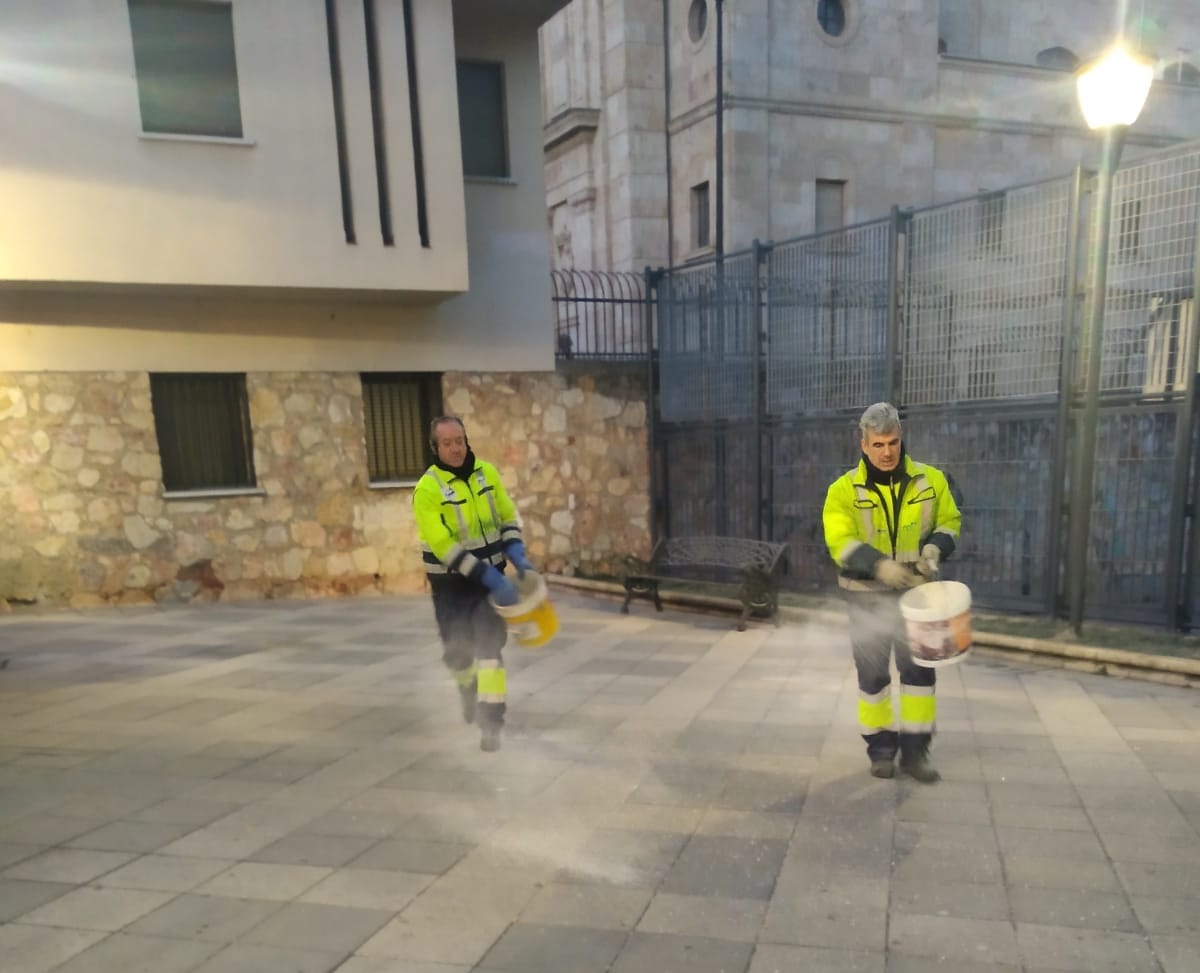 Operarios municipales esparciendo sal para evitar la formacion de placas de hielo
